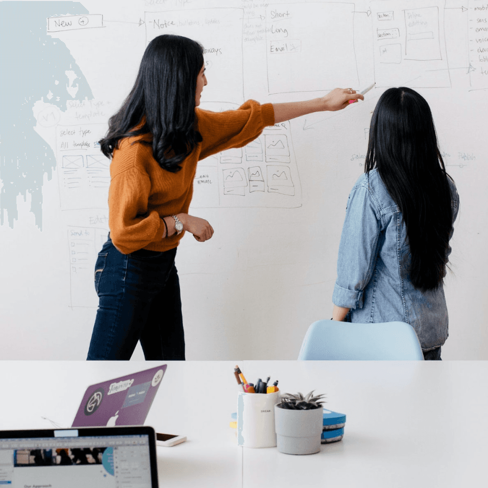 women looking at whiteboard