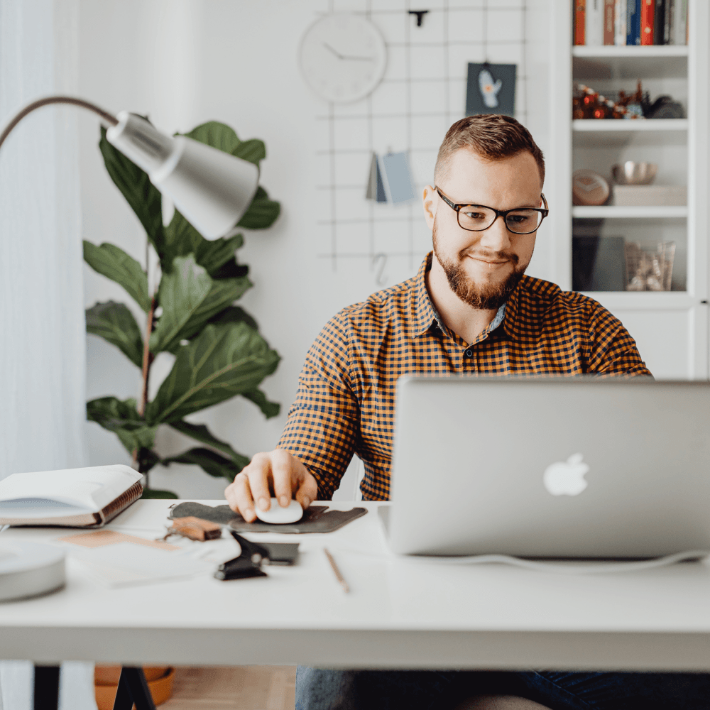 smiling man on computer