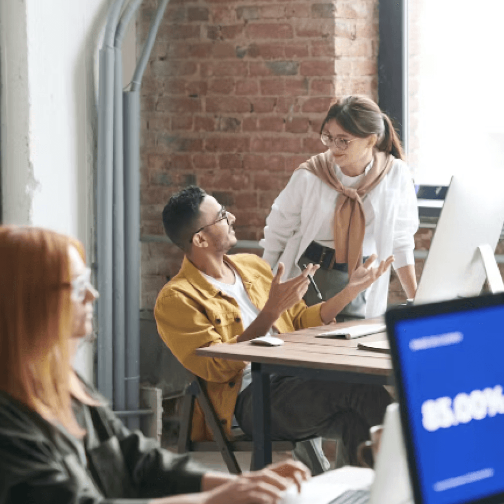 man and woman talking at work