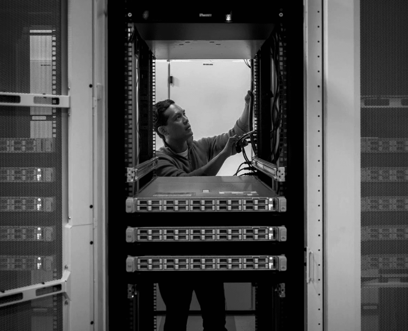 male worker installing cable at a data center